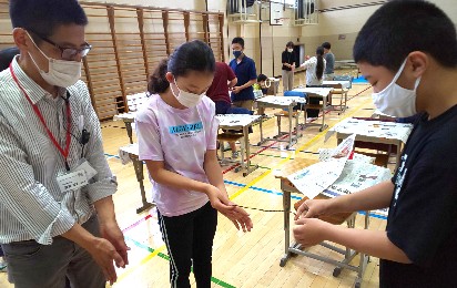 写真:湿らせた麻から紐を作る様子