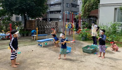 写真:友だちと一緒に水に親しむ子どもたち