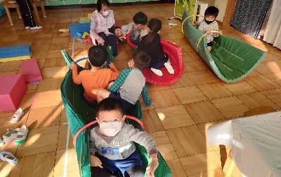写真:マットの船に乗って遊ぶ子どもたち