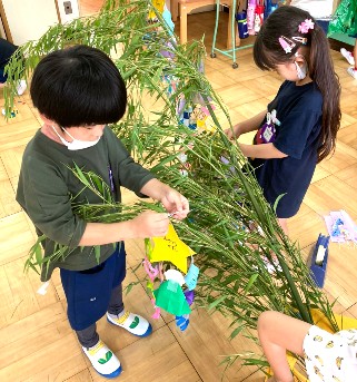 写真:笹に飾りを付ける子どもたち