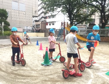 写真:スクーターで遊ぶ子どもたち