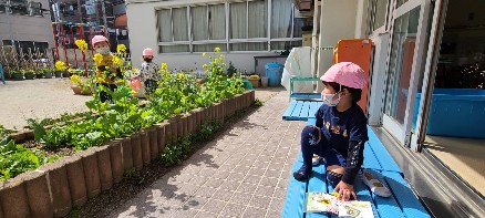 写真:咲いたお花を見る子ども