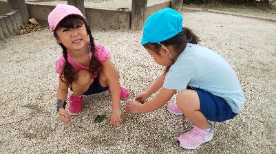 写真:一緒に砂遊びをする子どもたち