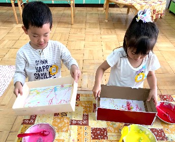 写真:ビー玉を転がす子どもたち